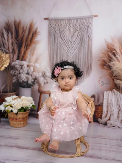 This little princess celebrates her first birthday with a beautiful boho-chic theme, featuring pampas grass, macrame details, and soft, earthy tones.