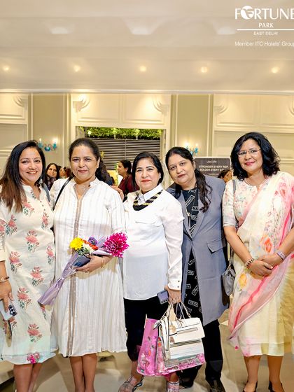 Guests posing for a photo during a social gathering at the hotel. I provide a sophisticated and welcoming backdrop for friends and groups to celebrate special occasions and create lasting memories together.