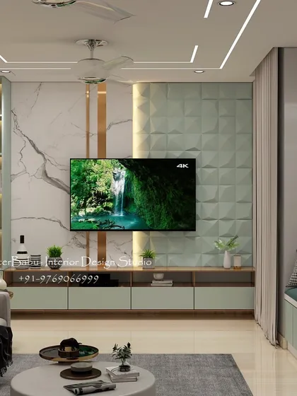 The TV unit in this 2BHK combines a marble-finish panel with a 3D geometric texture. A cozy window seat is integrated into the design, providing extra seating and a perfect reading spot.