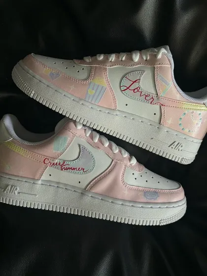 The full pair of Taylor Swift "Lover" custom sneakers, featuring different details on each shoe.