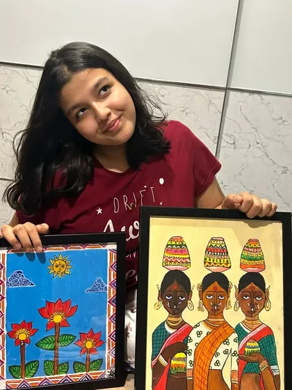 Here is one of our senior students, Adhya from the 11th standard, proudly showing her completed Madhubani paintings. We guide older students in advanced techniques like acrylics on canvas to create professional-quality folk art.
