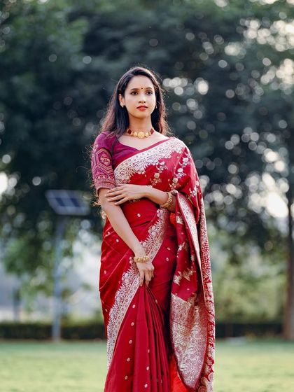 A full-length shot that captures the complete look, from the elegant saree to the traditional jewelry.