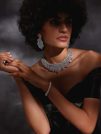 A portrait from the Purab Paschim "Luminance" campaign, featuring a model wearing an abstract design diamond necklace and earring set.