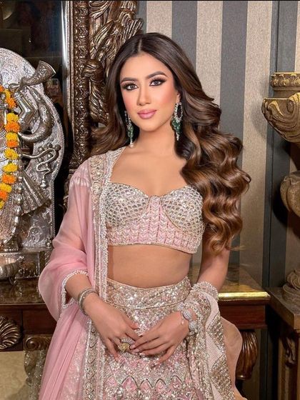 Big, glamorous waves for a client in a stunning pink Manish Malhotra lehenga. This look is all about making a grand entrance.