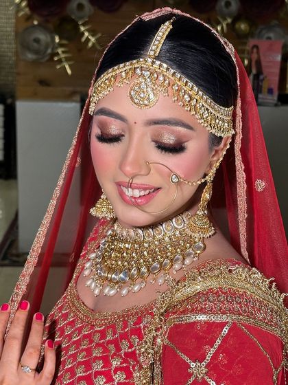 A close up of this stunning red bride. The golden shimmer on her eyelids and the perfectly blended base give her a radiant, lit from within glow.