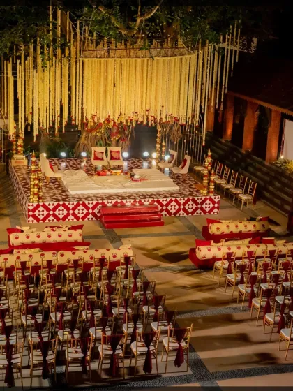 The wedding mandap was a visual delight. We created a grand stage with cascading strings of white flowers, traditional red and white patterned seating, and elegant gold chairs for the guests.