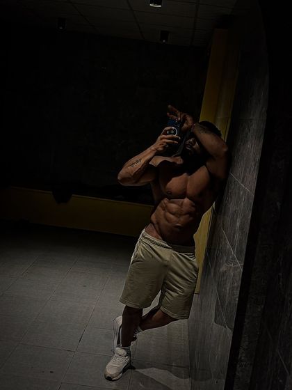A moody shot showing off the six-pack abs. This level of definition requires a very strict diet.