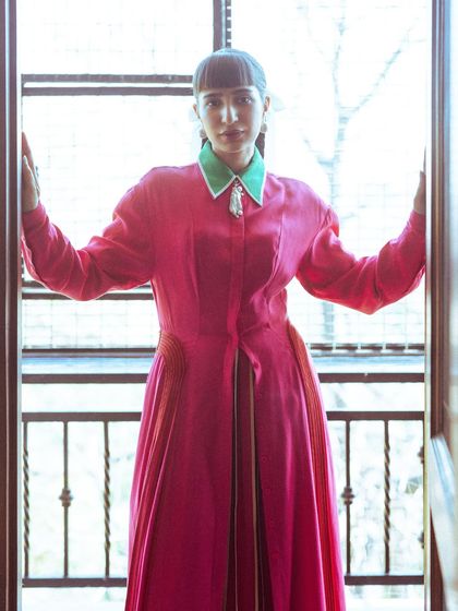 A portrait shot of the Bodice look. The contrasting green collar adds an unexpected pop of color to the pink and red palette.