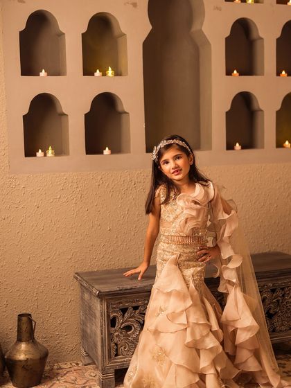 This ruffled ethnic dress in a soft beige is perfect for a Diwali party or festive gathering.