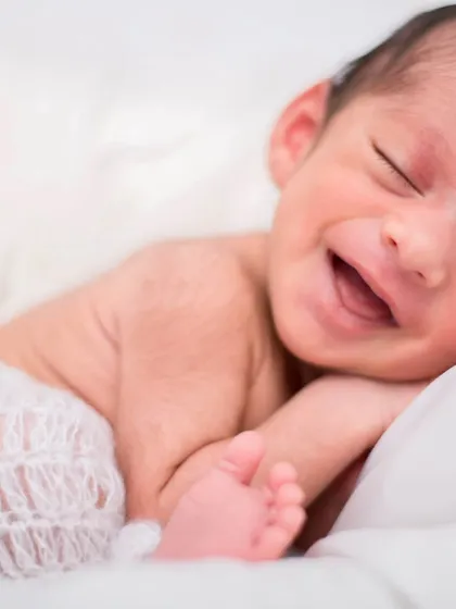 That first, pure smile is one of the most precious things to witness. I focus on creating a calm and comfortable space so we can capture these fleeting, natural moments of newborn joy.