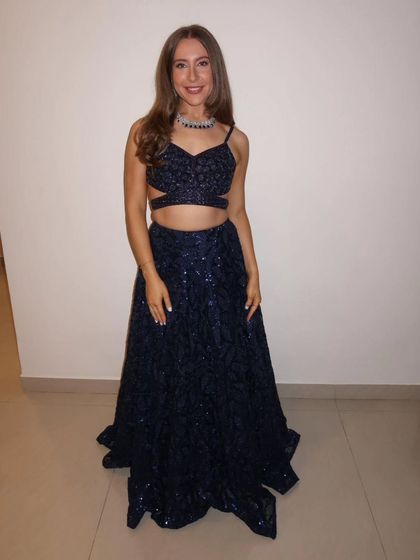 Another shot of our international client looking gorgeous in the navy blue lehenga. It's a modern and glamorous choice for any party.