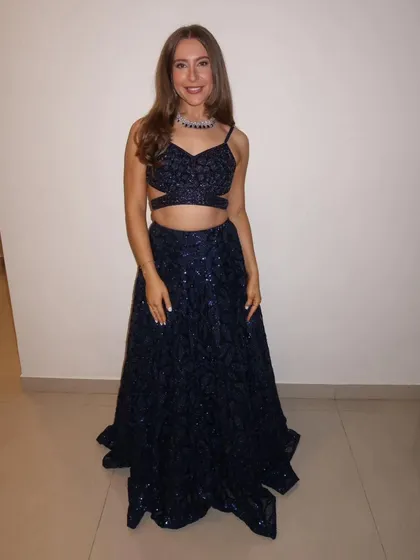 Another shot of our international client looking gorgeous in the navy blue lehenga. It's a modern and glamorous choice for any party.