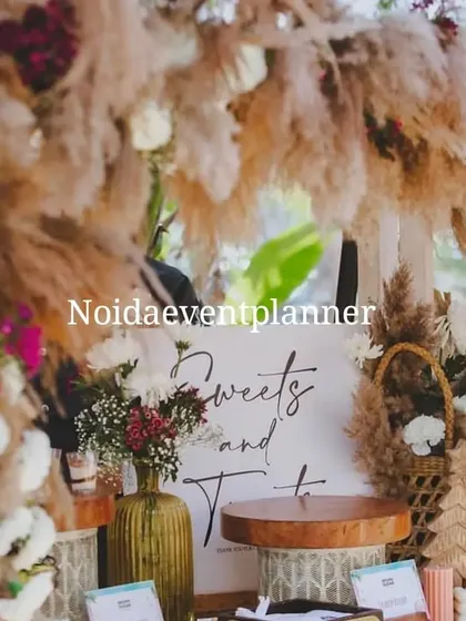 We believe gifting should complement your event's aesthetic. Here, our gift display is set up on a "Sweets and Treats" table at a boho-themed baby shower, blending seamlessly with the rustic pampas grass and wood decor.