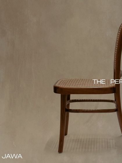 The 'Jawa' chair, a timeless design crafted from premium teak wood with a hand-caned seat and back. Its simple, elegant profile is perfect for dining or as an accent piece.