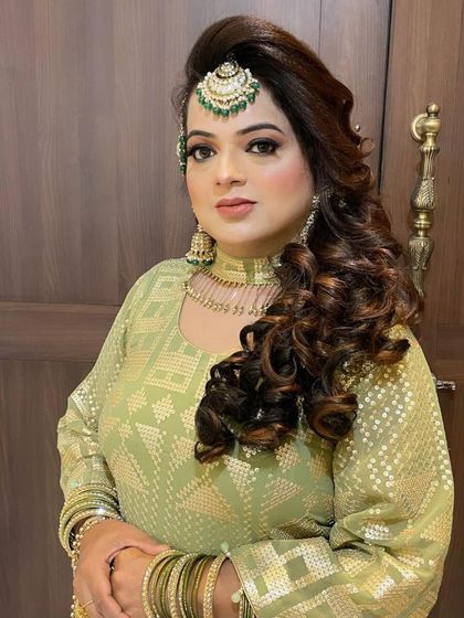 The bride looks absolutely stunning. Her intricate jewellery and flawless hair and makeup come together to create a breathtaking look.