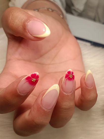 A close-up of the beautiful red blooming flower with a tiny gold stud in the center.