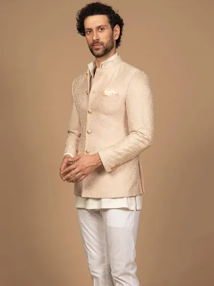 A side view of the peach embroidered bandhgala, showcasing its perfect fit and clean silhouette. It’s a testament to how bespoke tailoring can elevate even a simple design.