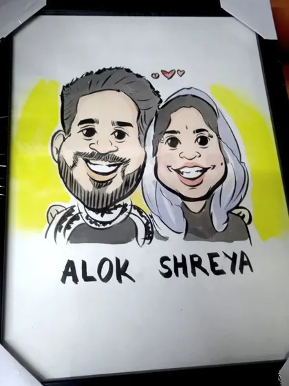 A framed caricature of a young couple, showcasing a simple yet expressive style. These custom portraits are shipped worldwide.