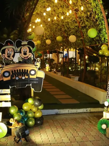 The complete entrance setup for the Mickey Mouse safari party. This wide shot shows how all the elements, from the welcome signs to the character cutouts and balloon arch, come together to create a grand welcome.