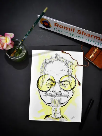 My workspace, where the magic happens. Here's a caricature of Sanjay Mishra on my desk, surrounded by my favorite pens, brushes, and a little bit of inspiration.