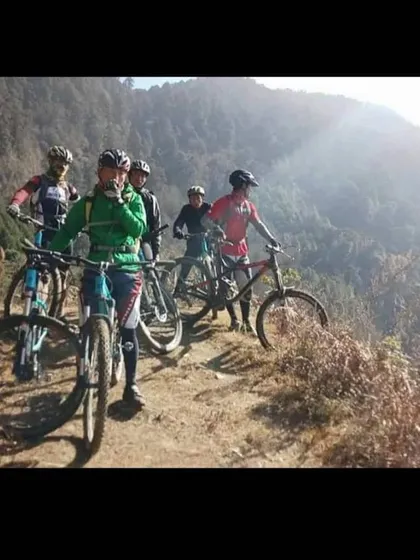 A group of riders taking a break on a high mountain trail in Bhutan. The views and the camaraderie make every climb worth it.