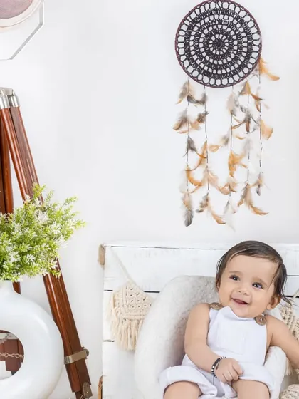 A happy baby boy in a white outfit, enjoying our simple and clean lifestyle set.