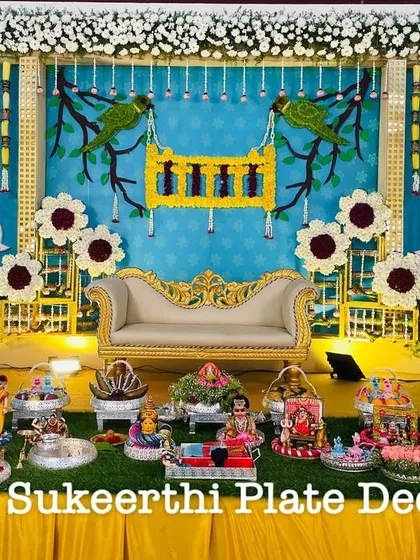 A beautiful baby shower (Valaikaappu) setup with a unique parrot and cradle theme. This shows how I can tailor the decorations, including the plates and backdrop elements, to match your specific vision for the day.