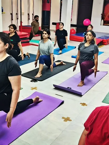 A full class engaged in Ashwa Sanchalanasana (Equestrian Pose), a powerful lunge that stretches the hips and strengthens the legs. Yoga truly heals the soul.