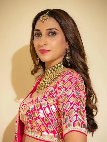 A close-up of the Mehendi makeup. The eyes are softly defined, and the skin is luminous, with a beautiful pink lip that ties the whole look together.