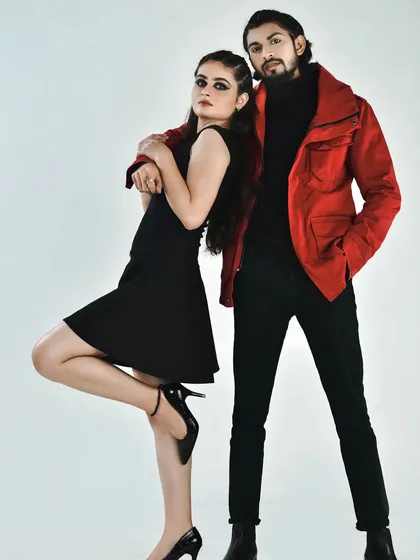 A full-length studio portrait for a couple's fashion shoot. I created coordinated looks with the female model featuring a sharp winged eyeliner and the male model styled for a clean, camera-ready appearance, showcasing my versatility for both male and female portfolio makeup.