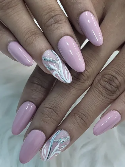 An elegant abstract design. We used a soft mauve polish as the base and created a delicate, flowing pattern with white and silver glitter lines on the accent nails.
