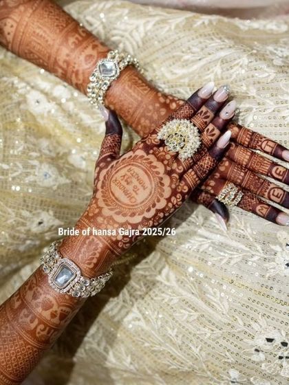 A close-up of a personalized back-hand design, showing the bride's name on her fingers and a custom quote on her palm, all beautifully integrated with traditional patterns.