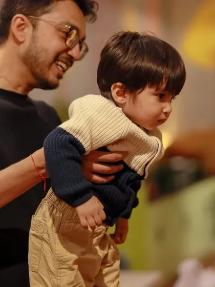 A father and son sharing a quiet moment amidst the fun. It's these connections that make playtime here so meaningful.