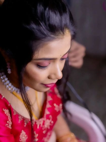 A close-up of the makeup application for a reception look. The pink eyeshadow is blended carefully for a soft, glamorous effect.