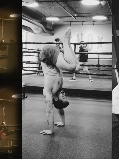 A black and white shot of a handstand, emphasizing the muscular definition and control required for advanced calisthenics.