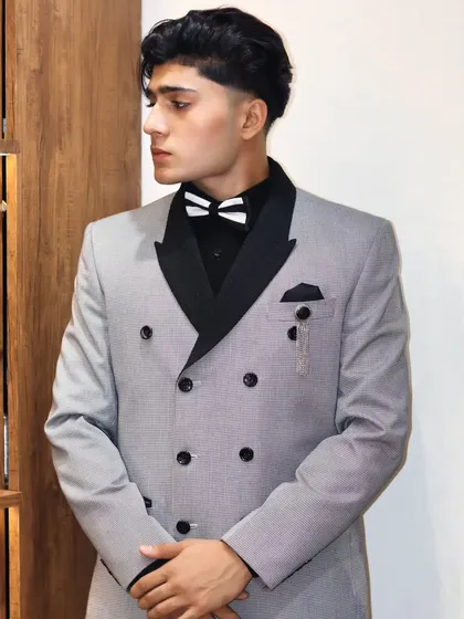 The details matter. This pinstripe double breasted jacket features a contrasting black lapel and pocket square, adding a touch of modern sophistication.