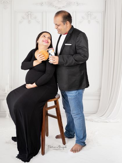 A fun and candid moment. This couple shares a laugh over burgers and drinks, creating a relaxed and authentic portrait.