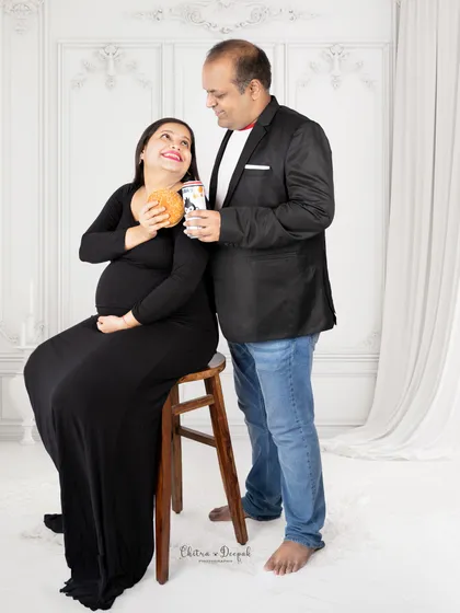 A fun and candid moment. This couple shares a laugh over burgers and drinks, creating a relaxed and authentic portrait.