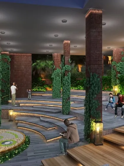 The central amphitheater at the Atmanya resort, a communal space designed with natural materials and integrated greenery to foster a sense of community and connection with the serene environment.