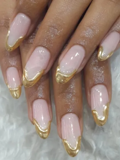 A luxurious and artistic take on the French tip. This design features a dripping liquid gold effect over a natural pink base on long, elegant nails.