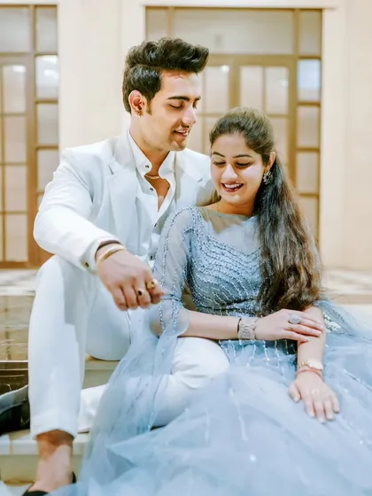 A candid moment of shared laughter and joy. This close-up shot captures the genuine happiness between the couple during their elegant indoor pre-wedding shoot.