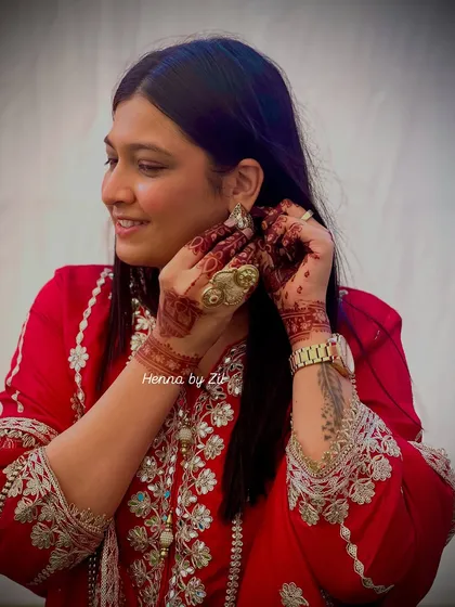 This is me, admiring the Shreenathji Mukharvin design I created for myself. It was so special to finally adorn my own hands with a design that is so close to my heart.