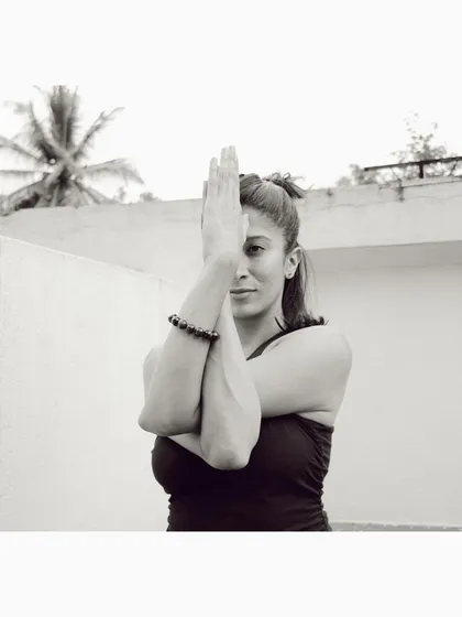 Finding stillness in the arms of Garudasana, or Eagle Pose. This simple wrap of the arms stretches the shoulders and upper back, but it's also a reminder to slow down, focus, and breathe. This is the essence of connecting mind and body in our practice.
