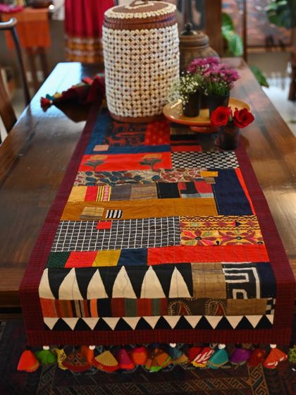 Another view of the autumnal scrap throw, showcasing its rich, earthy palette and complex composition.