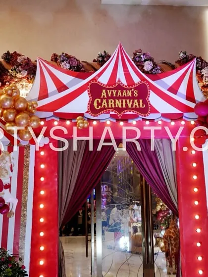 Our custom-built props transform any venue into a different world. This entrance for a carnival-themed party features a large, detailed circus tent structure with integrated lighting and classic red-and-white stripes, immediately immersing guests in the funfair atmosphere.