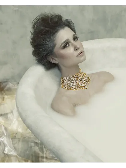 This image is from my "Sculptured Portraits" series, where I explore the intersection of art and photography. The concept was to treat the subject like a classical sculpture, using the milky bath to create texture and the exquisite jewelry as the focal point. It's about creating a timeless piece of art.