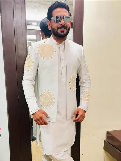 A serene all-white ensemble for a Navratri night. The jacket features beautiful, subtle pearl and mirror work, creating a look of understated elegance.