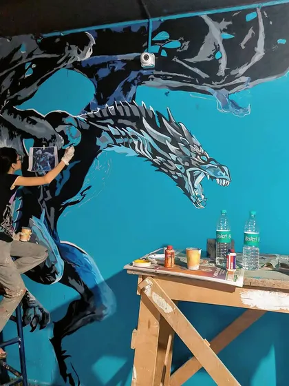 Painting the icy dragon Viserion for the Game of Thrones themed pub, Westeros. This was part of a massive 45 foot wall, and we loved getting all the details right.