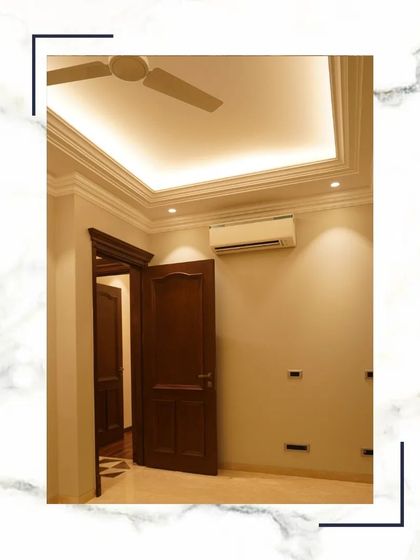 This bedroom features a simple, clean design with warm wooden doors and a false ceiling with cove lighting. It's a comfortable and sophisticated space, ready for personalization.