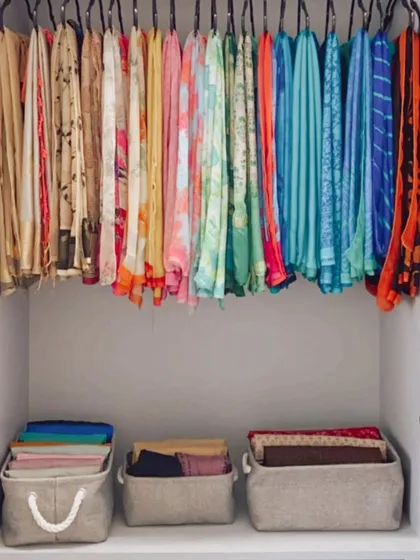 A pro tip for utilizing the space below your hanging clothes. We use organizers that act like drawers, allowing you to access the full depth of the shelf easily.